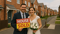 A realistic image of a smiling bride and groom celebrating the purchase of their first home in a new-build UK estate, symbolising affordable housing, homeownership, and young family stability.